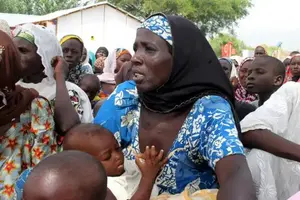 A woman who was rescued after being held captive by Boko Haram, attends to her baby at an internally displaced person's camp near Mubi, northeast Nigeria October 29, 2015. REUTERS/Stringer