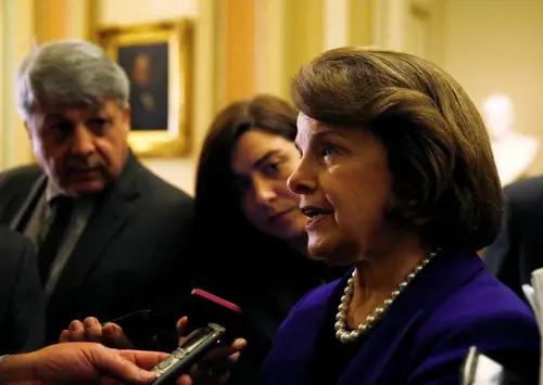 Senate Intelligence Committee chair Senator Dianne Feinstein (D-CA) (R) talks to reporters after coming out of the Senate in Washington December 9, 2014. 