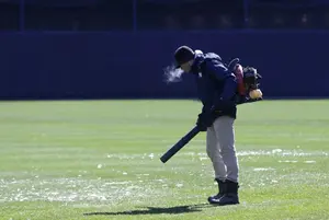 A member of the grounds crew blows