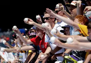 Fans ask for autographs during batting practice at