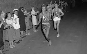 TO GO WITH AFP STORY BY CYRIL BELAUD (FILES) This file photo taken on September 10, 1960 shows Ethiopian athlete Abebe Bikila  running barefoot for victory during the Rome 1960 Olympic Games marathon, after passing Moroccan Abdeslam Radi. Ethiopia's athlete Abebe Bikila, the legendary bare foot runner opened the way to the Olympic glory to African runners, with his victory in the marathon during the 1960 Olympic Games edition in Rome, before dying in a car accident. / AFP PHOTO / EPU / -