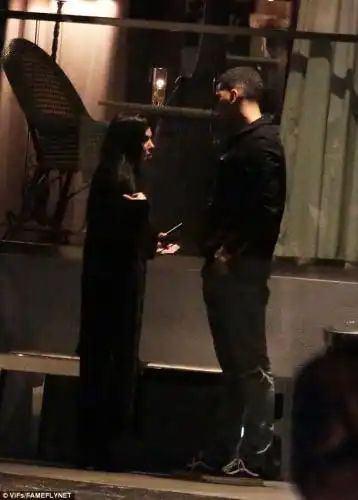 Having a word: Kourtney and the model chatted with each other in the cold winter weather