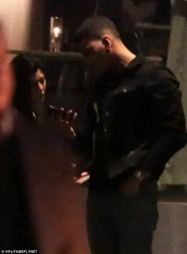 Taking a look: The former boxer glanced down at his phone 