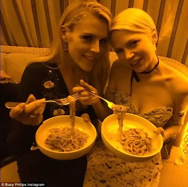 Carb loading: Busy and Michelle hilarious tried to reverse the process by tucking into a plate of past at the Chateau Marmont as they 'hadn't eaten carbs in a week'