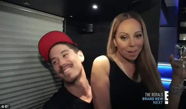 On the lap: Mariah made herself comfortable on Tanaka's lap