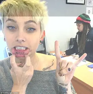 Paris has 50 tattoos already with nine devoted to her dad. She has MOTLEY inked on her inner lip and Faith, trust and pixie dust on her clavicle