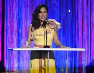Not so mellow yellow: Salma Hayek sported an intricate cannery-coloured number