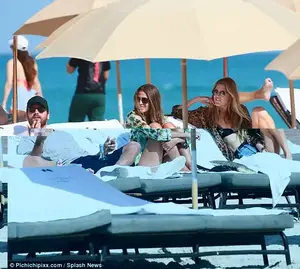 Catching up: The KUWTK star appeared to have a bottle of water between his legs as he chatted with some ladies
