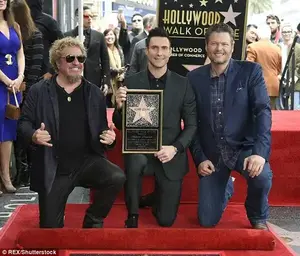 He's happy!  The Maroon 5 front man happily posed with his honor alongside his colleagues