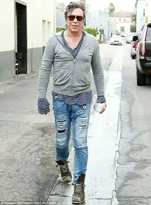 Letting rip: The fitness fanatic showed off his toned legs in a pair of torn jeans