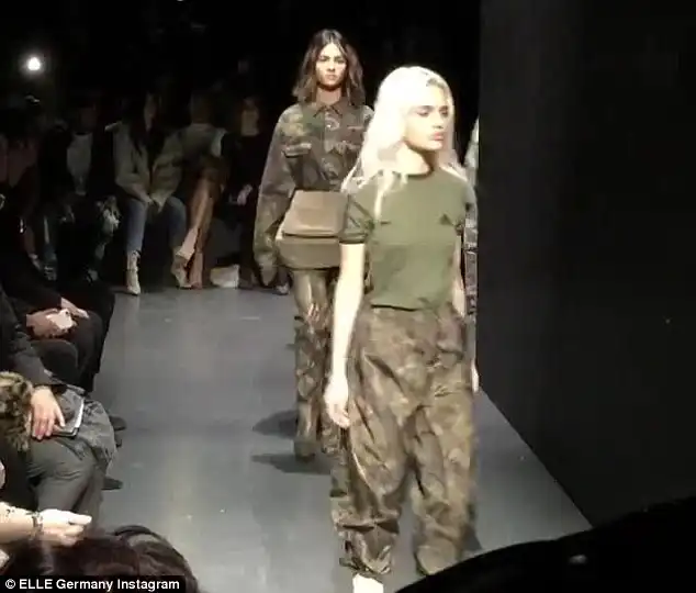 All in a line: The show kicked-off around 3pm ET with images of models projected onto a screen at the center of the runway, Vogue reports