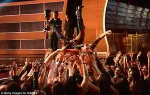 There she goes: Gaga dived into the crowd for some body surfing as she got into the heavy metal spirit