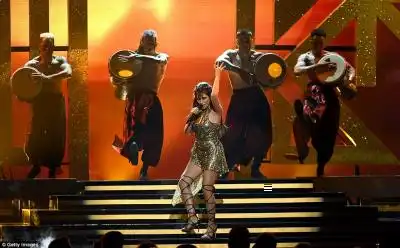 Golden girl: She wore a sparkling gold mini dress as she performed new single I Have Questions 
