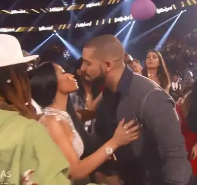 Sweet smooch: Drake kissed Nicki Minaj as he won his third award of the night
