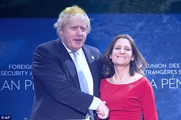 Canadian Minister of Foreign Affairs Chrystia Freeland, right, greets UK Foreign Secretary Boris Johnson