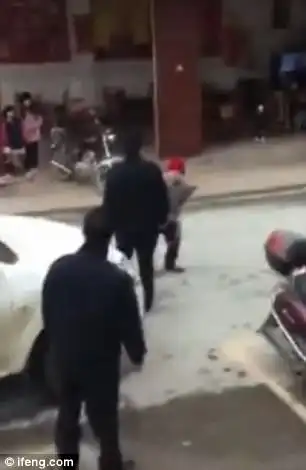 The pensioner is trying to defend her stall but the officers take away her tools and throws her vegetables away
