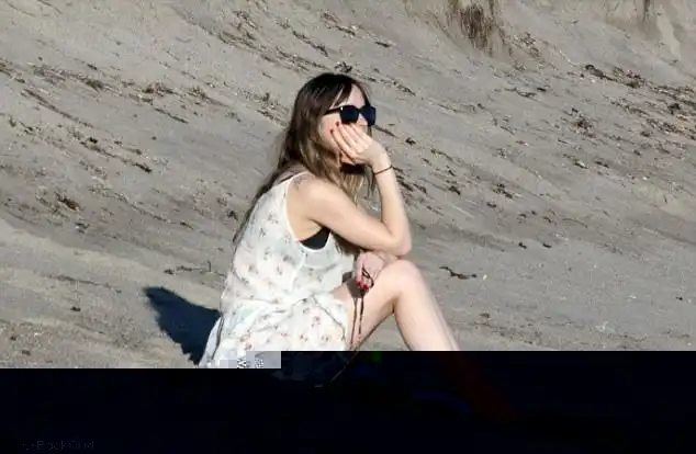 Peaceful: Dakota, who is the daughter of Melanie Griffith and Don Johnson, had her brunette locks loose around