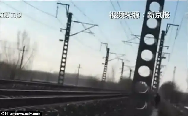 The screen shot shows Mr Zhang walking along train tracks before being killed by a locomotive