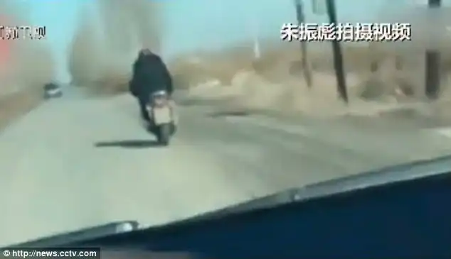 A video taken by Zhu Zhengbiao shows him chasing Zhang Yonghuan who had hit another motorcyclist and run away from the scene in Hebei, China. Mr Zhang was later killed by a train