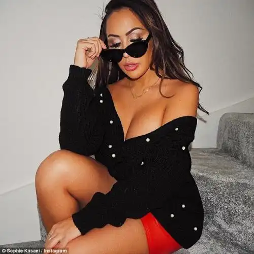 Shady: She also shared a snap of herself in shades as she sheltered from the bad weather, quipping: 'Wearing sunglasses constantly to block out all haters'