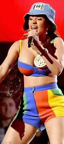When you got it, flaunt it: Cardi, who shot to fame last year on the tide of her hit single Bodak Yellow, showed off her legs in a pair of high-waisted blue, crimson, yellow and green shorts