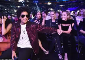 Sharing the love: Man of the hour Bruno shook hands with Miley as they enjoyed the show together