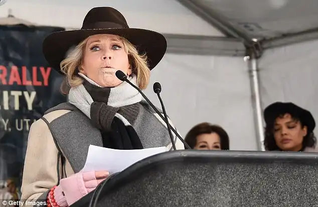 Getting the word out: Fonda, 80, looked impassioned as she took the podium in a black hat, beige-and-grey coat, large scarf and pink gloves with several orange beaded bracelets