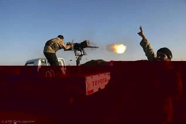 Turkish-backed fighters fire towards YPG positions in the Tal Malid area, north of Aleppo