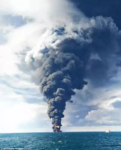 The Chinese freighter's 21 crew members were all accounted for. The burning oil tanker's crew consisted of 32 members