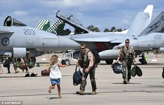 The air force personnel created a heroic scene as they strode across the tarmac smiling and carrying their baggage