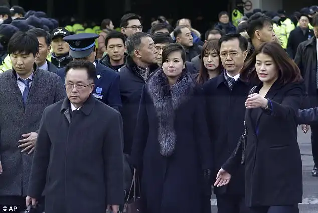 Hyon (pictured centre), who is also an alternate member of the ruling party's Central Committee, was travelling with six other North Koreans