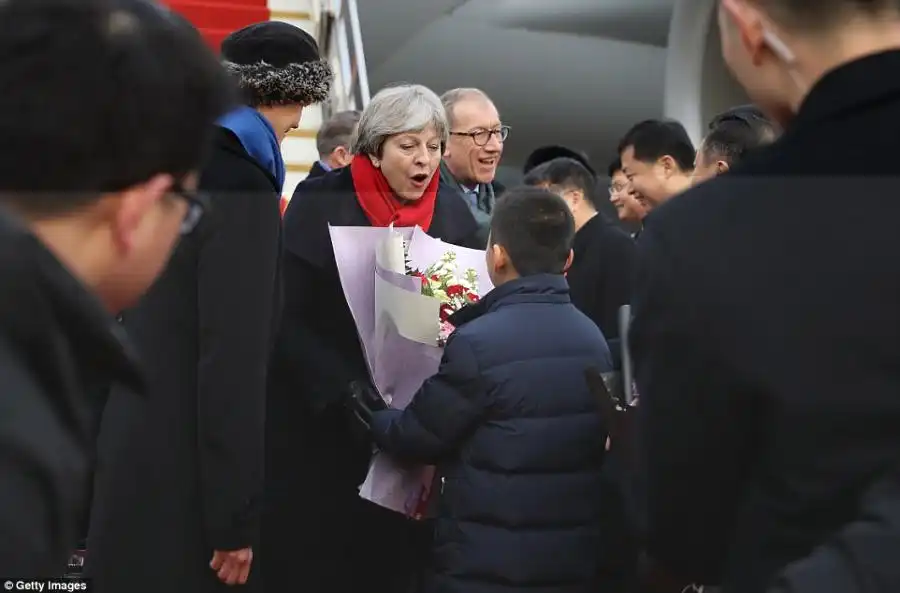 Mrs May (pictured, after landing at Wuhan Airport) said she was leading the trade delegation to China to enhance the British economy and enhance 'Global Britain'