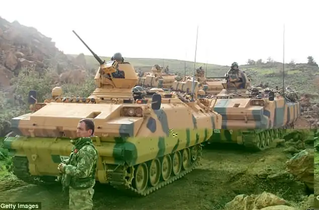 Turkey has launched a major operation to oust US-backed Kurdish militias from an inside Syria near the countries’ border (Pictured: Turkish soldier pictured today as they move towards the Syrian border)