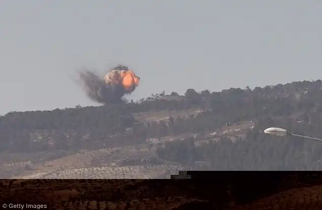 Smoke rises from Burseya Mountain amid the airstrikes. The hill is significant because it overlooks the towns of Kilis and Azaz, either side of the Turkish-Syrian border