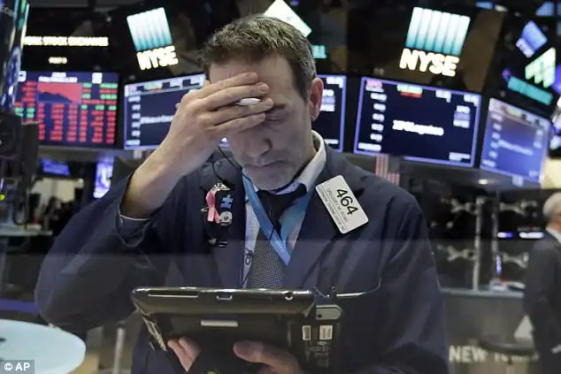 Trader Gregory Rowe works on the floor of the New York Stock Exchange, which watched as the Dow Jones lose as much as 1,000 this week