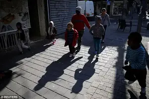 Safe: Deportation notices are only being handed out to men with no dependents in Israel who have not been awarded asylum. All women and children are allowed to stayfor now. Pictured: African migrant children in Tel Aviv last week