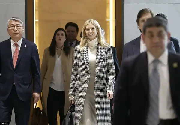 The first daughter opted for a white and black hounds tooth coat, a white roll-neck jumper, matching skirt and heavy back boots as she climbed off the plane 