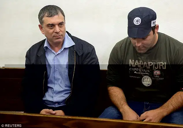 Under arrest: Former  director general of Israel's Communications Ministry, Shlomo Filber, left, sits at the Magistrate Court during his remand in Tel Aviv, Israel on Sunday