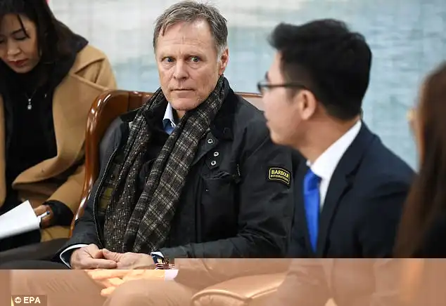 North Korea has accused the United States of waging a 'defamation campaign' against Pyongyang after inviting Fred Warmbier (centre), the father of late prisoner Otto Warmbier to the Winter Olympics