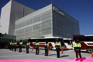 Police officers stand guard outside the Gangneung Art Center while members of North Korea's Samjiyon art troupe tour the facility prior to the 2018 Winter Olympics