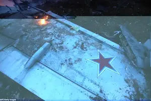 The wing of a downed Sukhoi-25 fighter jet with a red star in the the Syrian city of Saraqib, southwest of Aleppo