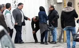 Families console each other after learning that a plane crashed into mountains over Iran