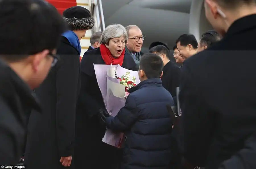 Mrs May (pictured, after landing at Wuhan Airport) said she was leading the trade delegation to China to enhance the British economy and enhance 'Global Britain'