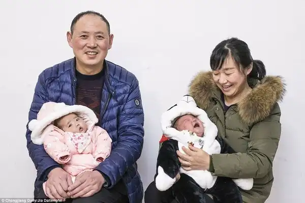 The couple is pictured with their twins on March 2 as they celebrate the traditional Lantern Festival at their home in Suizhou