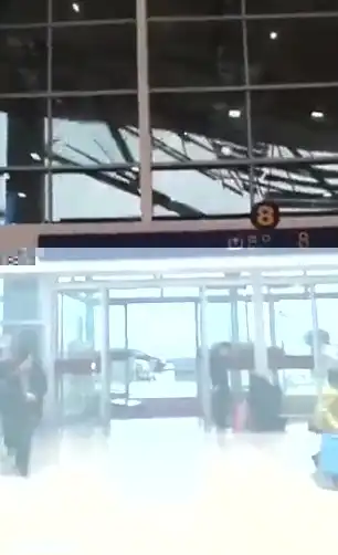 People inside the airport look on in fear