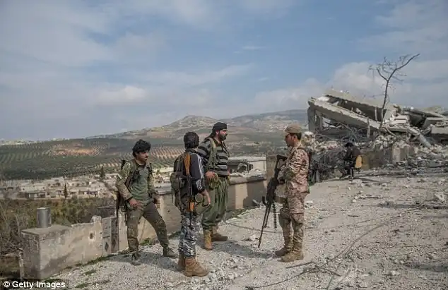 Members of Free Syrian Army, backed by Turkish Armed Forces are seen as they stand guard at Rajos town center  during the Operation Olive Branch in Syrias northwestern Afrin region