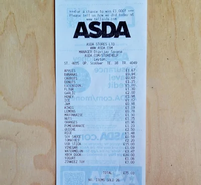 Man creating receipt art by buying a supermarket A to Z and mocking Trump