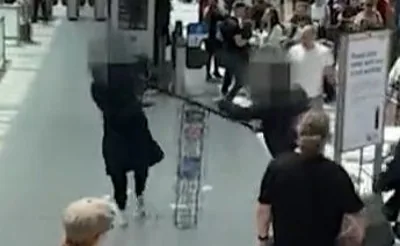 A man tries to fend off an attacker at London Underground station Earl's Court using a metal leaflet stand before TfL staff pinned him down.