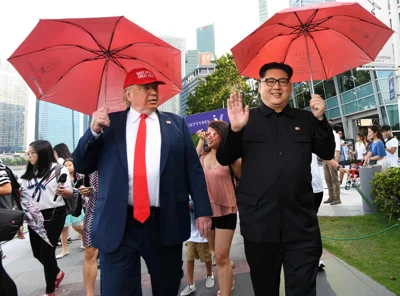 North Korean leader Kim Jong Un impersonator Howard X (R) and Donald Trump impersonator Dennis Alan (L) walk along the Merlion park in Singapore on June 8, 2018. / AFP PHOTO / ROSLAN RAHMANROSLAN RAHMAN/AFP/Getty Images
