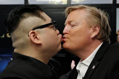 Howard X, an Australian impersonating North Korean leader Kim Jong Un, kisses an impersonator of U.S. President Donald Trump at the La Paix Hotel in Hanoi, Vietnam February 25, 2019. REUTERS/Jorge Silva